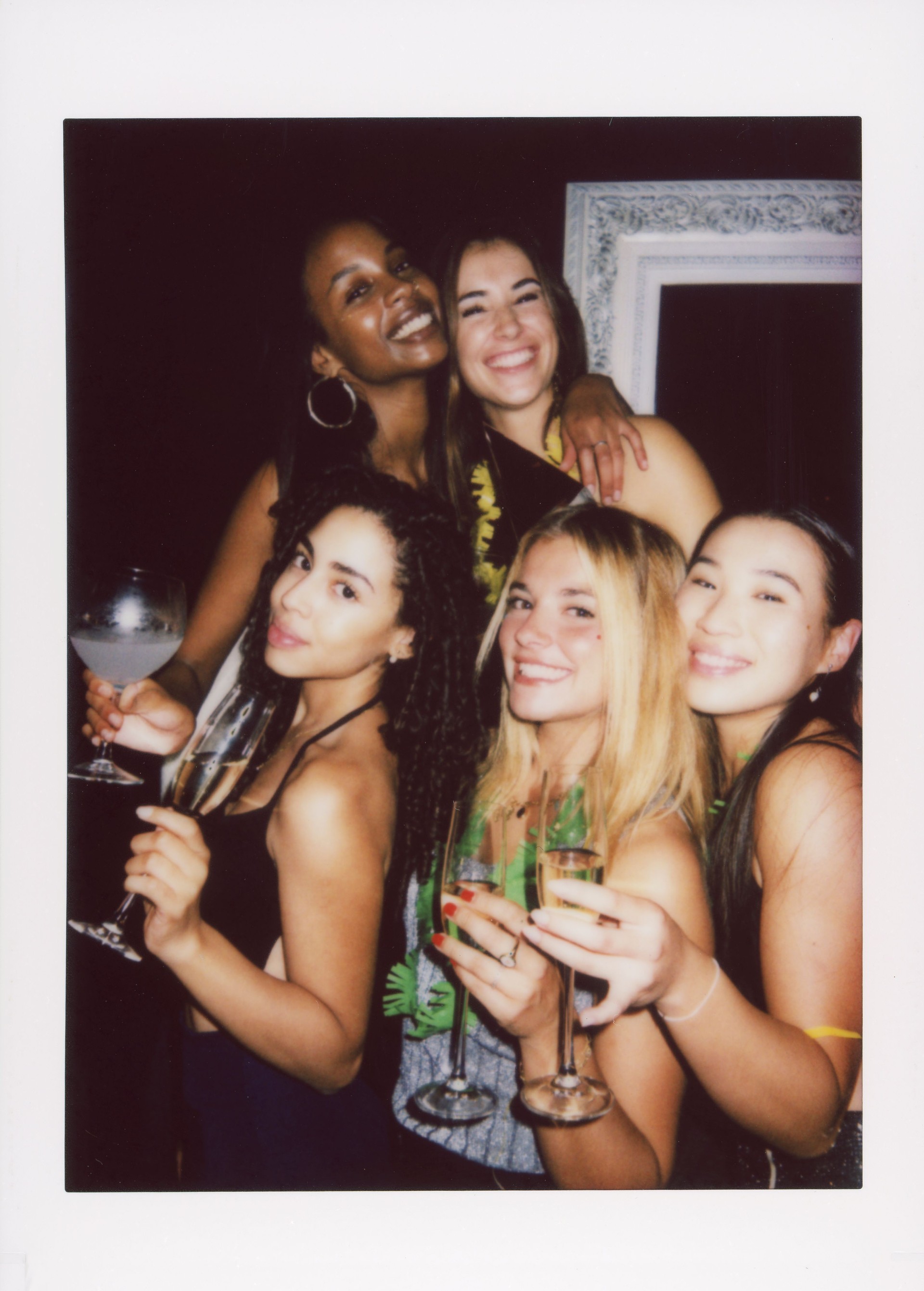 Group of friends celebrating with drinks at a festive party